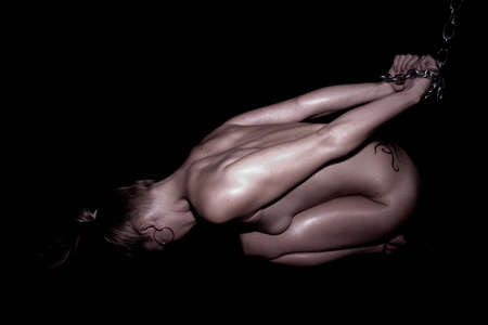 sexy nude blonde female tied with chains の写真素材