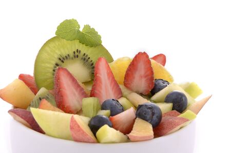Different fruits as fruit salad in a white bowl, white background, isolatedの写真素材