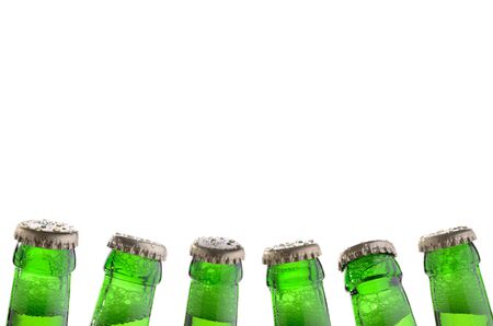 six green bottle necks with bottle caps, white background, isolatedの写真素材