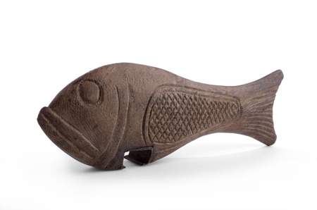 carved african bottle opener in form of a fish, white backgroundの写真素材
