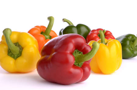 seven sweet pepper fruits of different color, isolated, white background, close upの写真素材