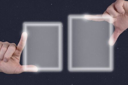 two hands describe, touch touchscreen in front of starsの写真素材