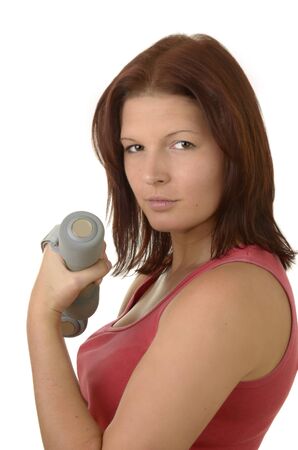 Portrait of a young woman during power training in pink top on White Backgroundの写真素材