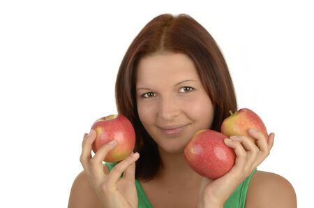 Young pretty woman in green top holding three apples, smiling,  portrait, Isolatedの写真素材