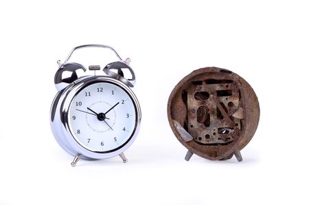 A new and an old alarm clock, isolated, studio still