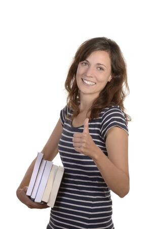pretty young student with books, studio shot, isolatedの写真素材