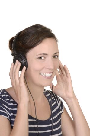 young girl listening to music with headphones studio shot, isolatedの写真素材