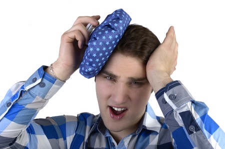 Young man in blue shirt has bad headacheの写真素材