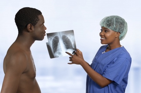 African Doctor explaining X-Ray image to Patient, Studio Shotの写真素材