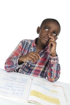 African boy thinking with text book, Studio Shotの写真素材