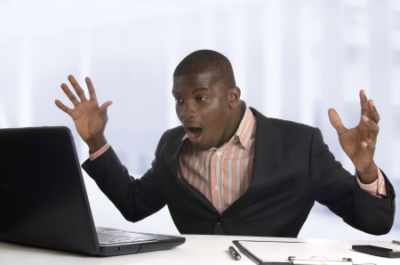 Surprised african business man with notebook, Studio Shotの写真素材