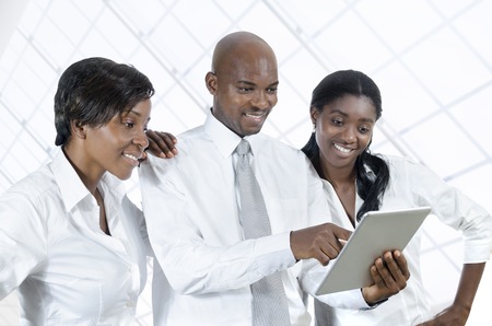 Three african business people with tablet PC, Studio Shotの写真素材
