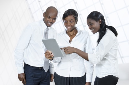 Three african business people with tablet PC, Studio Shotの写真素材