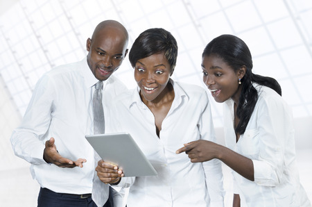 Three african business people with tablet PC, Studio Shotの写真素材