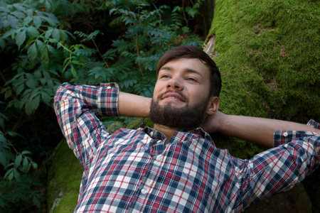 Young man relaxing in nature, outdoor shotの写真素材