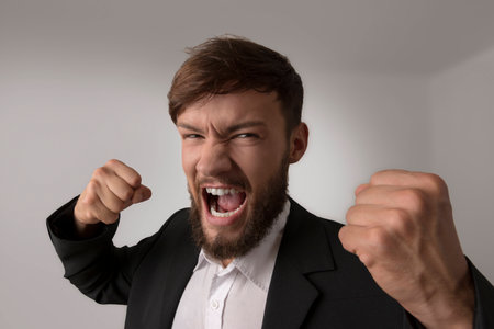 Angry man with clenched fists, studio shotの写真素材