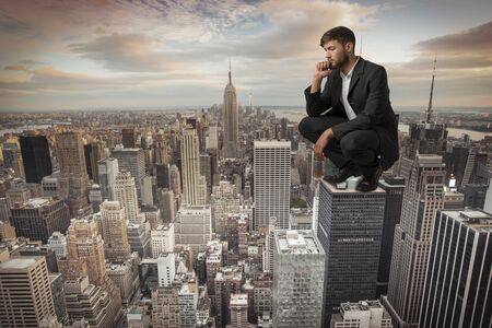 Man sitting on Skyscraper Studio Shot Montageの写真素材