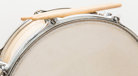 Wood snare drum and drumsticks isolated in white background