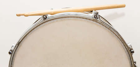 Wood snare drum and drumsticks isolated in white backgroundの写真素材