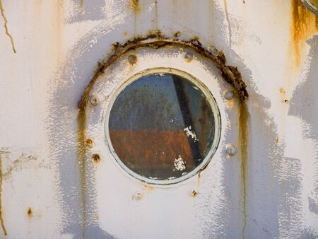 Detail on a rusty old ship windowの写真素材