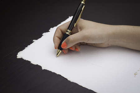 Woman about to write on a recycle black paperの写真素材