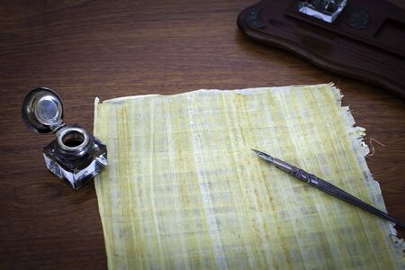 Old papyruns on a desk with ink and penの写真素材