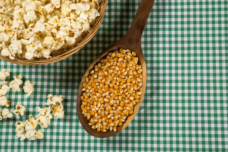 Ear of corn, revealing yellow kernels of maize in a wicker basketの写真素材