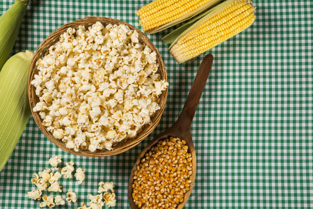 Ear of corn, revealing yellow kernels of maize in a wicker basketの写真素材