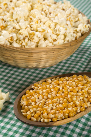 Ear of corn, revealing yellow kernels of maize in a wicker basketの写真素材