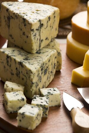 Different cheeses on a cutting board, delicious foodの写真素材