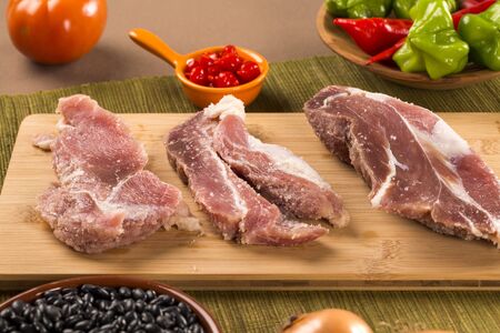 Pig loin raw in wooden backgroundの写真素材