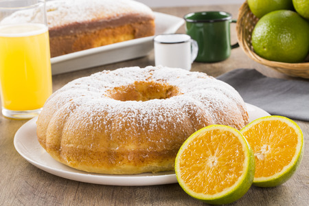 Orange cake on the table with fruits and juice.の写真素材