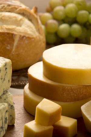Different cheeses on a cutting board, delicious foodの写真素材