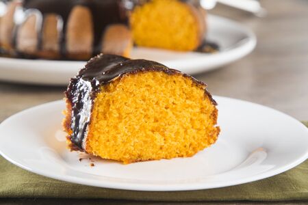 Carrot cake with chocolate and slice on the table.の写真素材