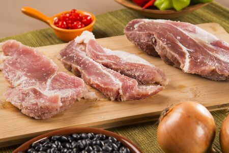 Pig loin raw in wooden backgroundの写真素材