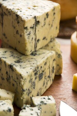 Different cheeses on a cutting board, delicious foodの写真素材
