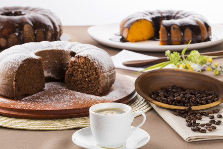 Chocolate cake on the table with carrot cake in the background.の写真素材
