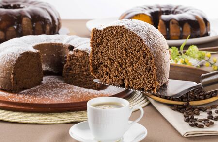 Chocolate cake on the table with carrot cake in the background.の写真素材