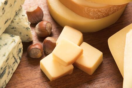 Different cheeses on a cutting board, delicious foodの写真素材