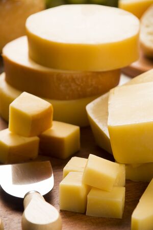 Different cheeses on a cutting board, delicious foodの写真素材