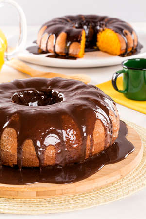 Carrot cake with chocolate and slice on the table.の写真素材