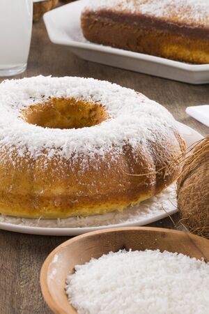 coconut cake with slice on the tableの写真素材