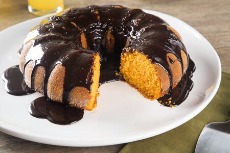 Carrot cake with chocolate and slice on the table.の写真素材