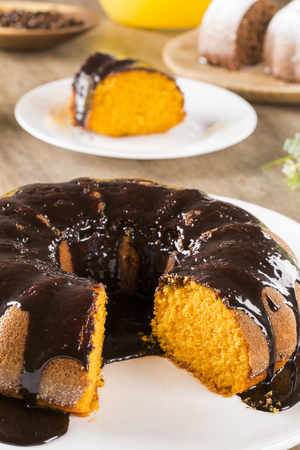 Carrot cake with chocolate and slice on the table.の写真素材