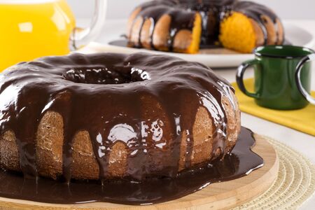 Carrot cake with chocolate and slice on the table.の写真素材