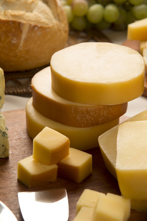 Different cheeses on a cutting board, delicious foodの写真素材