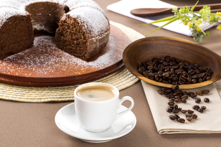 Chocolate cake on the table with cooffe in the background.の写真素材