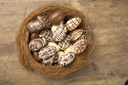 Chocolate Easter Eggs Over Wooden Background. Easter Egges desserts.の写真素材