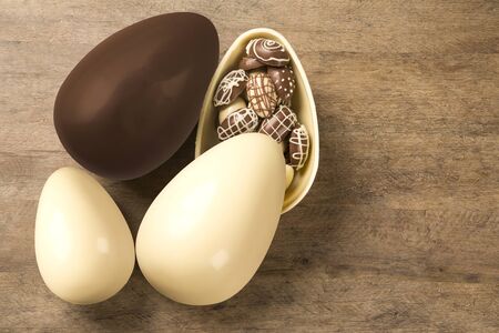 Chocolate Easter Eggs Over Wooden Background. Easter Egges desserts.の写真素材