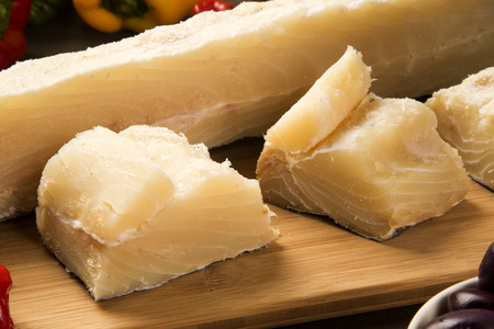 salted codfish on the wooden table with ingredients. Cod Fish Raw.
